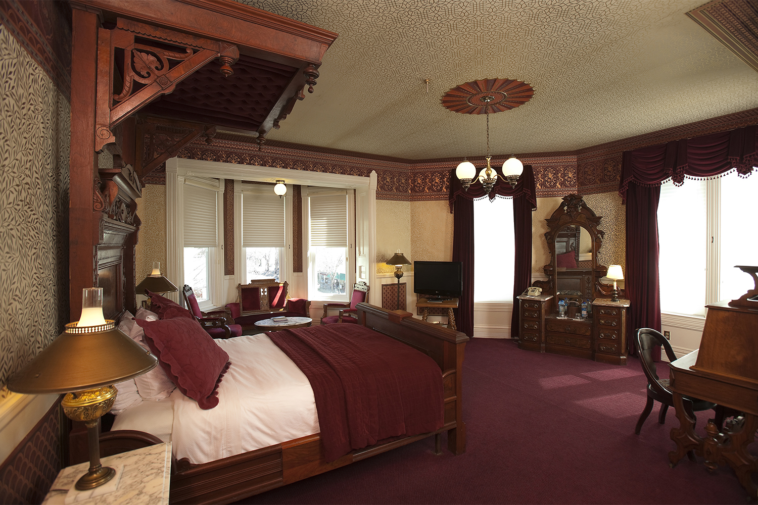 Image of Guestroom with Sitting Area and Antique Desk The Strater Hotel Durango Colorado